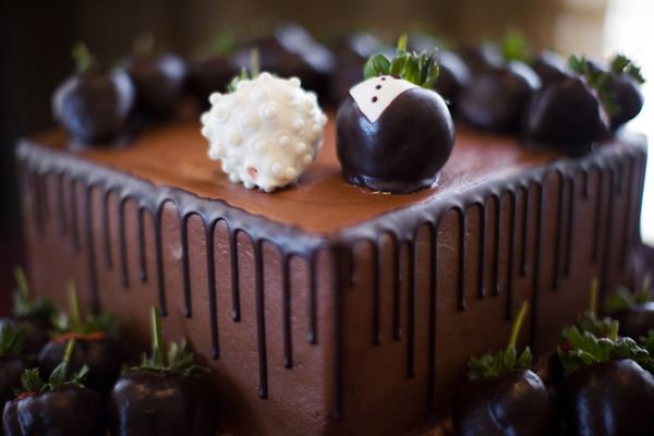 Cute chocolate cake with purple strawberry topper -  wedding photo by Melissa Jill Photography